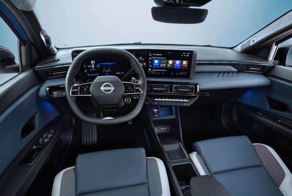 Driver pov of full dashboard cockpit showing steering wheel, driver focused infotainment, rear view mirror, front seats and side mirrors